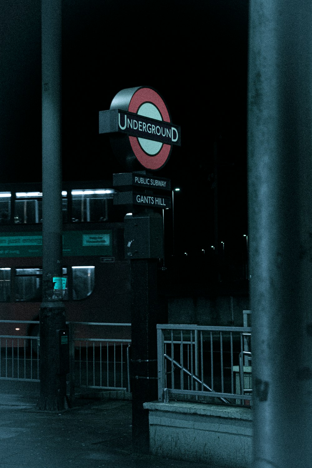 a sign for a train station at night