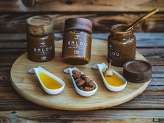 a wooden tray topped with jars filled with different types of condiments