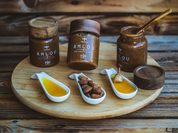 a wooden tray topped with jars filled with different types of condiments