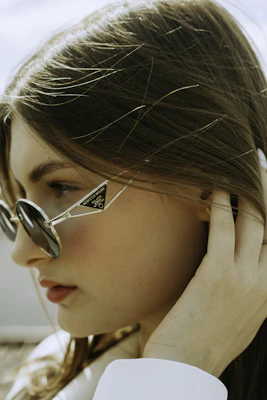 a woman wearing glasses and a white shirt