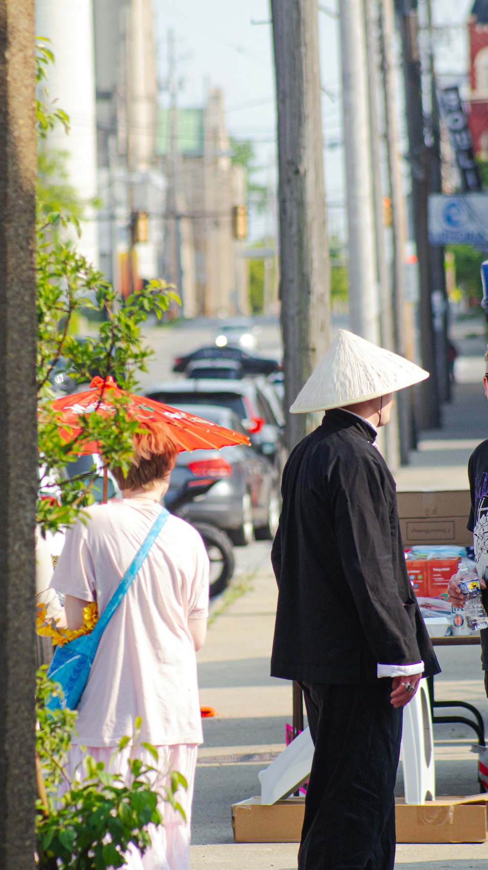 a group of people standing on a sidewalk