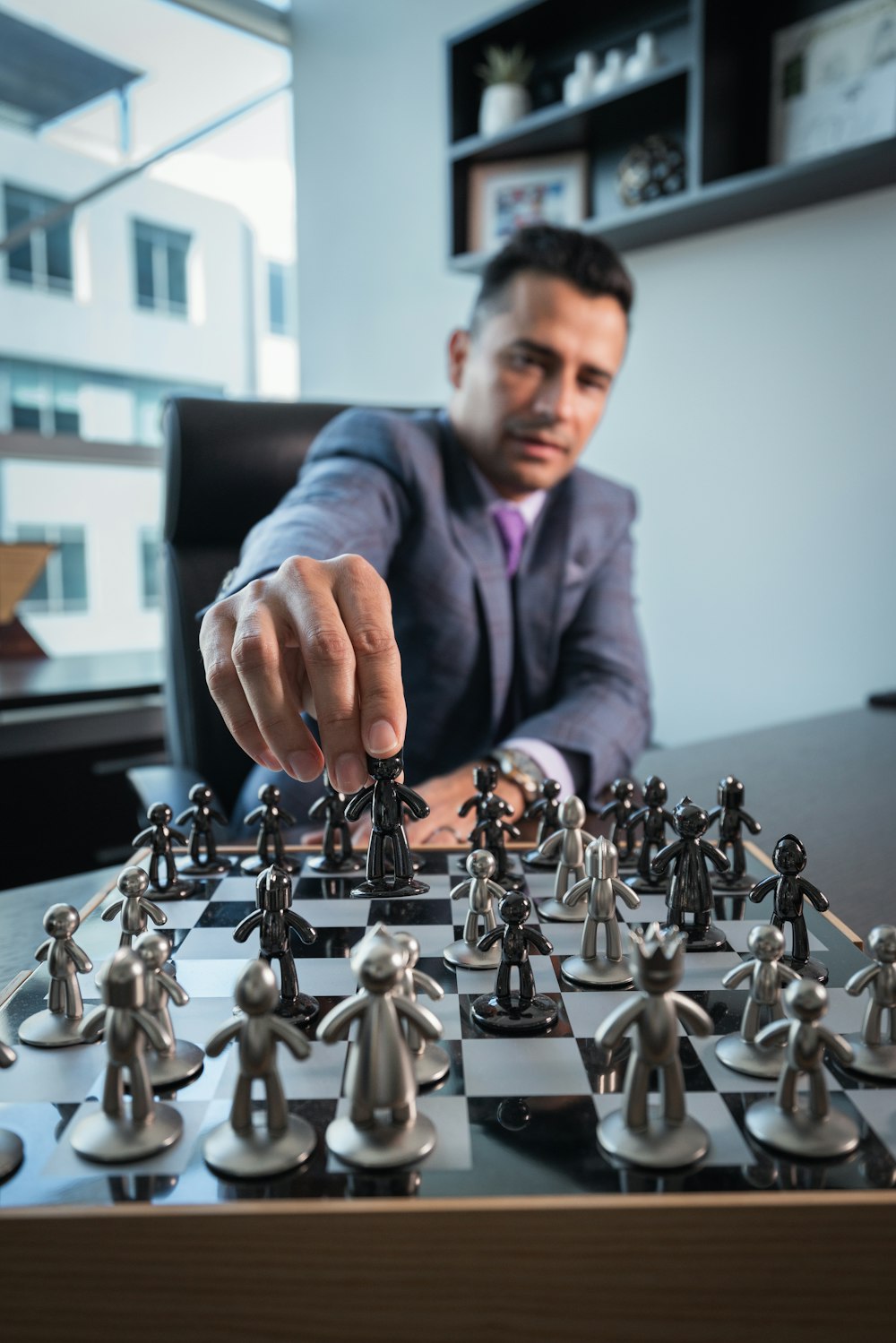 a man in a suit playing a game of chess