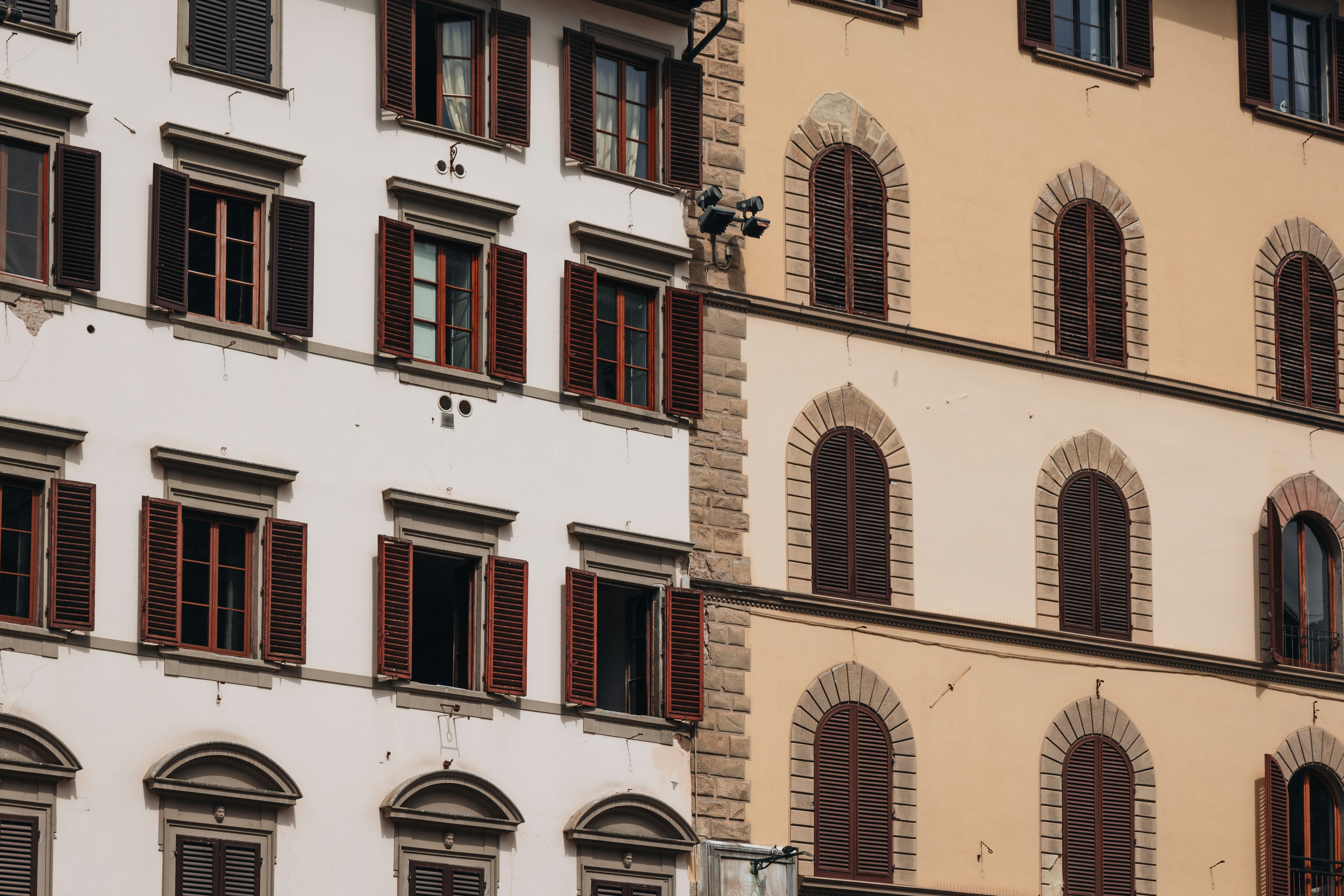 A tall building with lots of windows and shutters
