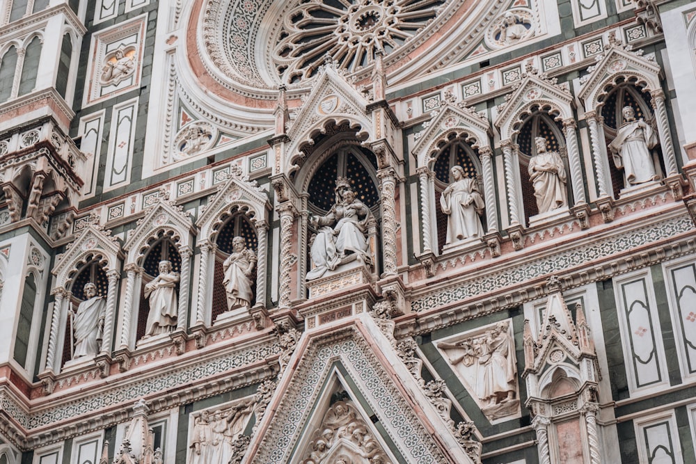 a close up of a building with statues on it