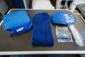 a blue bag sitting on top of a table next to a blue towel