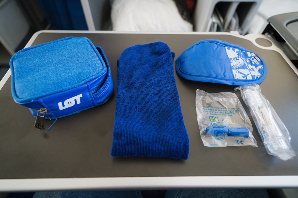 a blue bag sitting on top of a table next to a blue towel