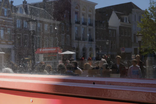Before-and-after image of a glass storefront after hard-water stain removal.