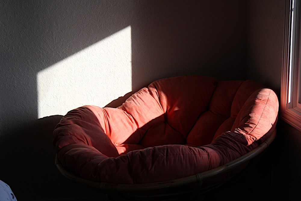 a dog bed sitting in the corner of a room