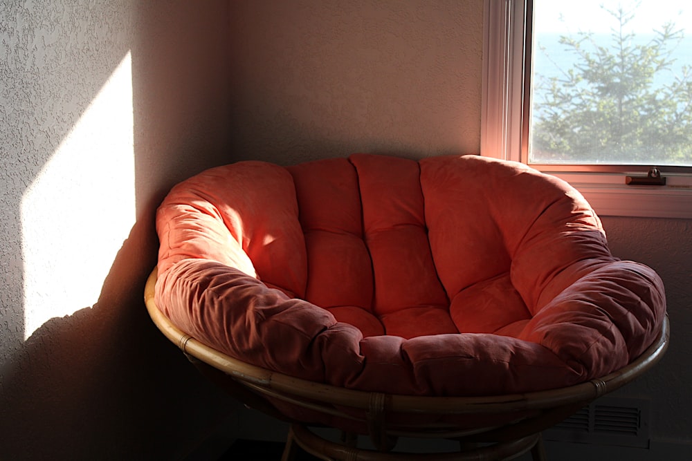 a chair sitting in front of a window in a room