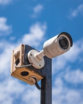 a security camera attached to a metal pole