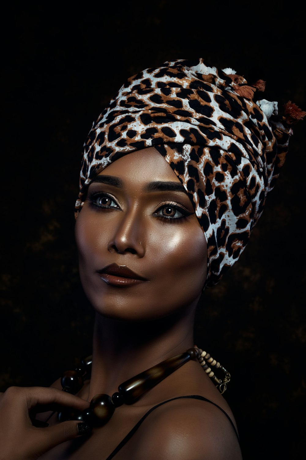 a woman wearing a leopard print head wrap