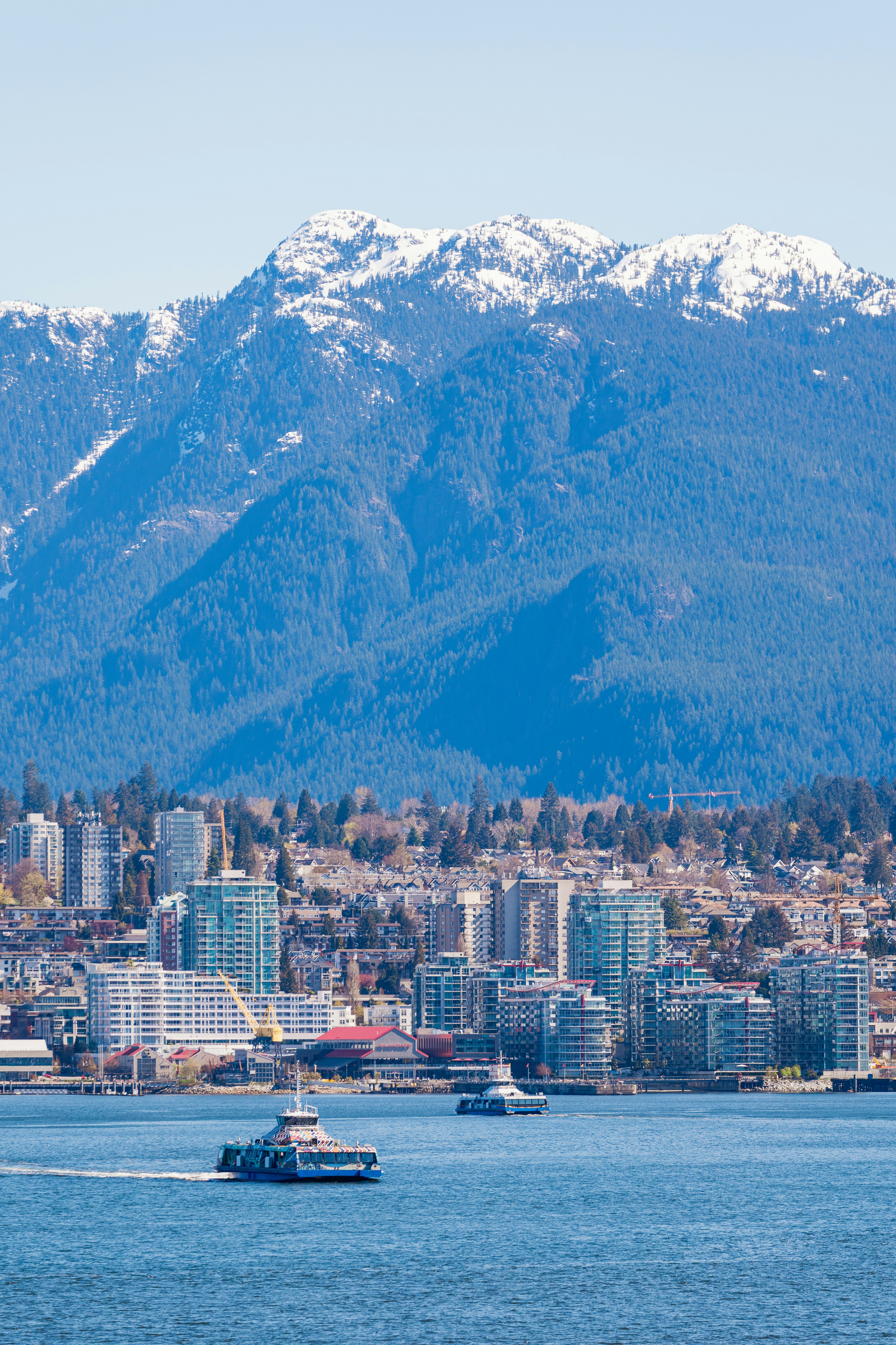a boat in the water with a city in the background