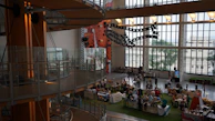 A panoramic view of a large exhibition space filled with multiple stands designed by Formavista.