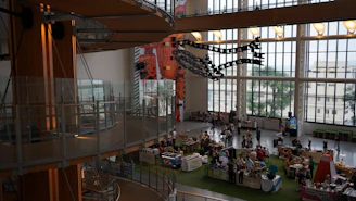 A welcoming local marketplace scene showing diverse professionals from architecture, design, and construction collaborating.