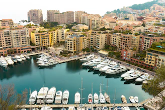 A panoramic view of The Landing's modern luxury condominiums with the sparkling ocean and marina beyond.