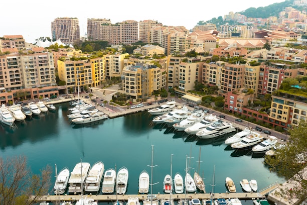 Modern condo balcony overlooking the marina filled with yachts and vibrant Cabo nightlife.