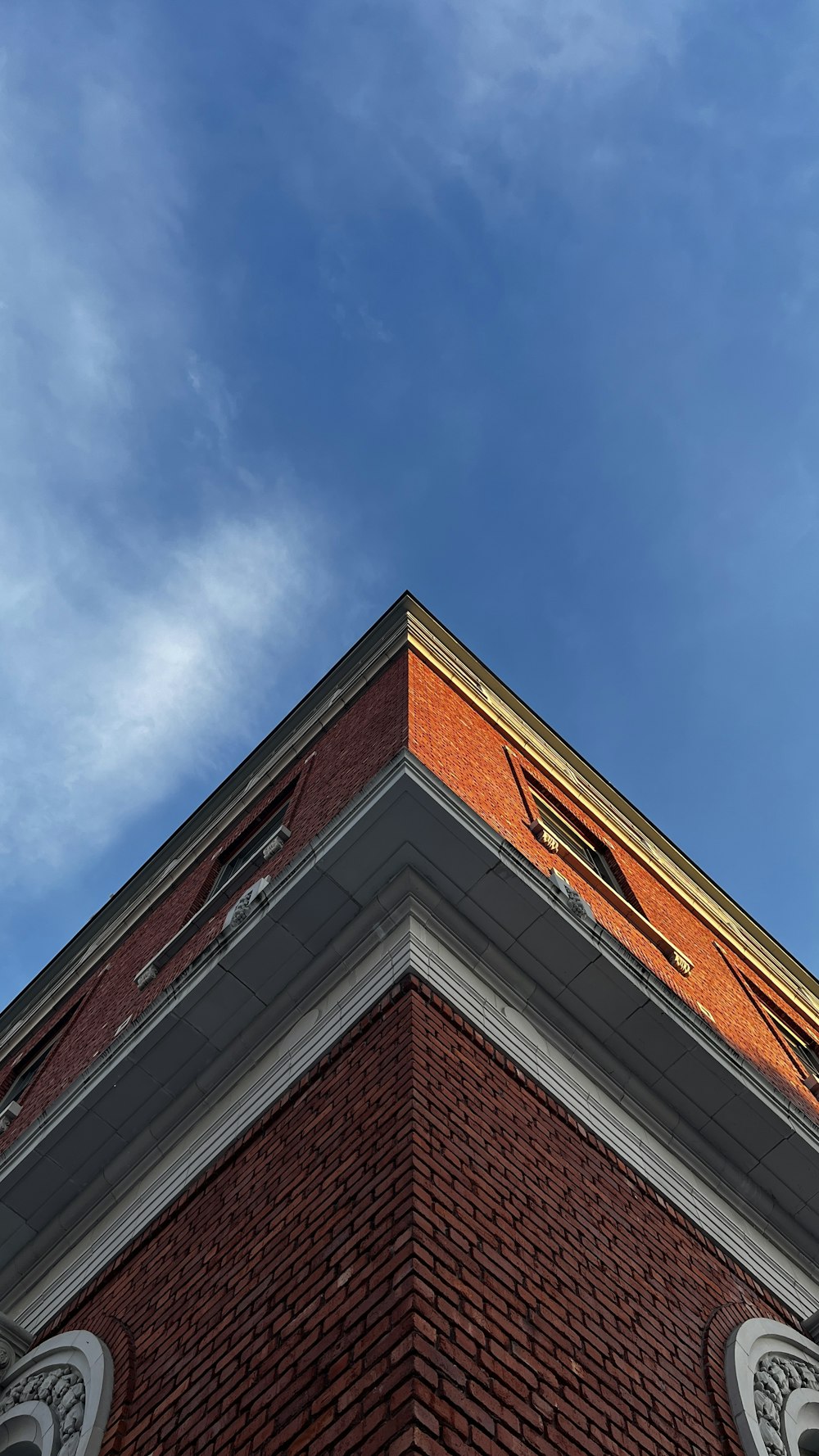 a tall brick building with a clock on it's side