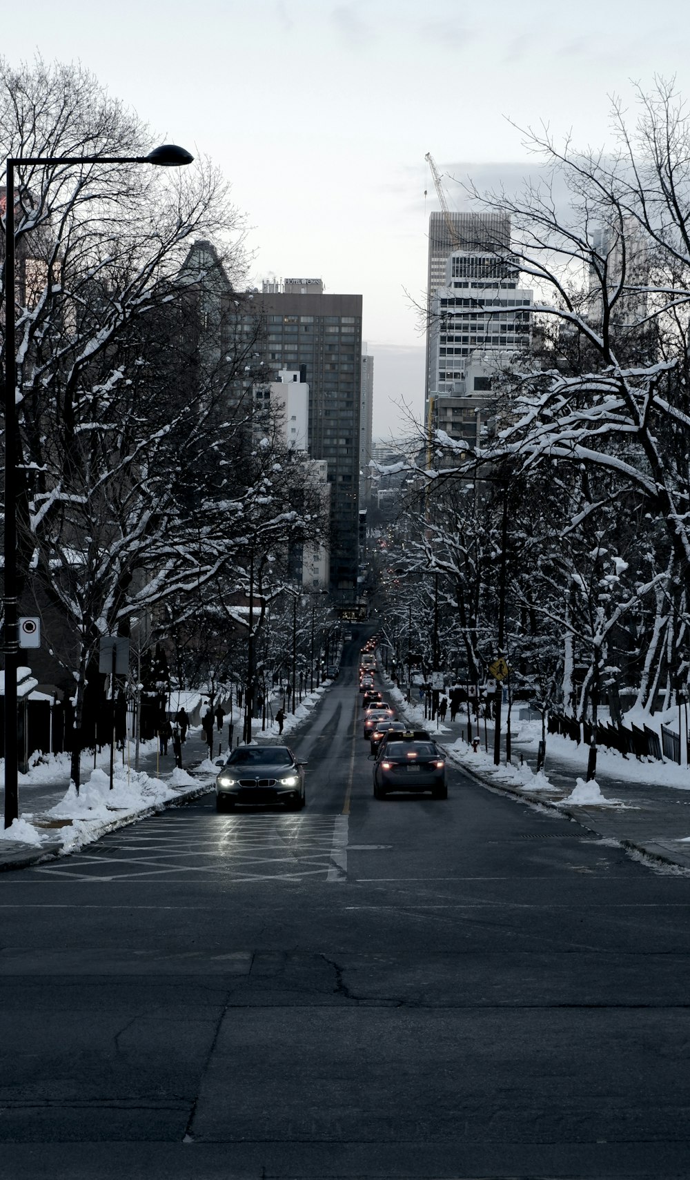 a street filled with lots of traffic next to tall buildings