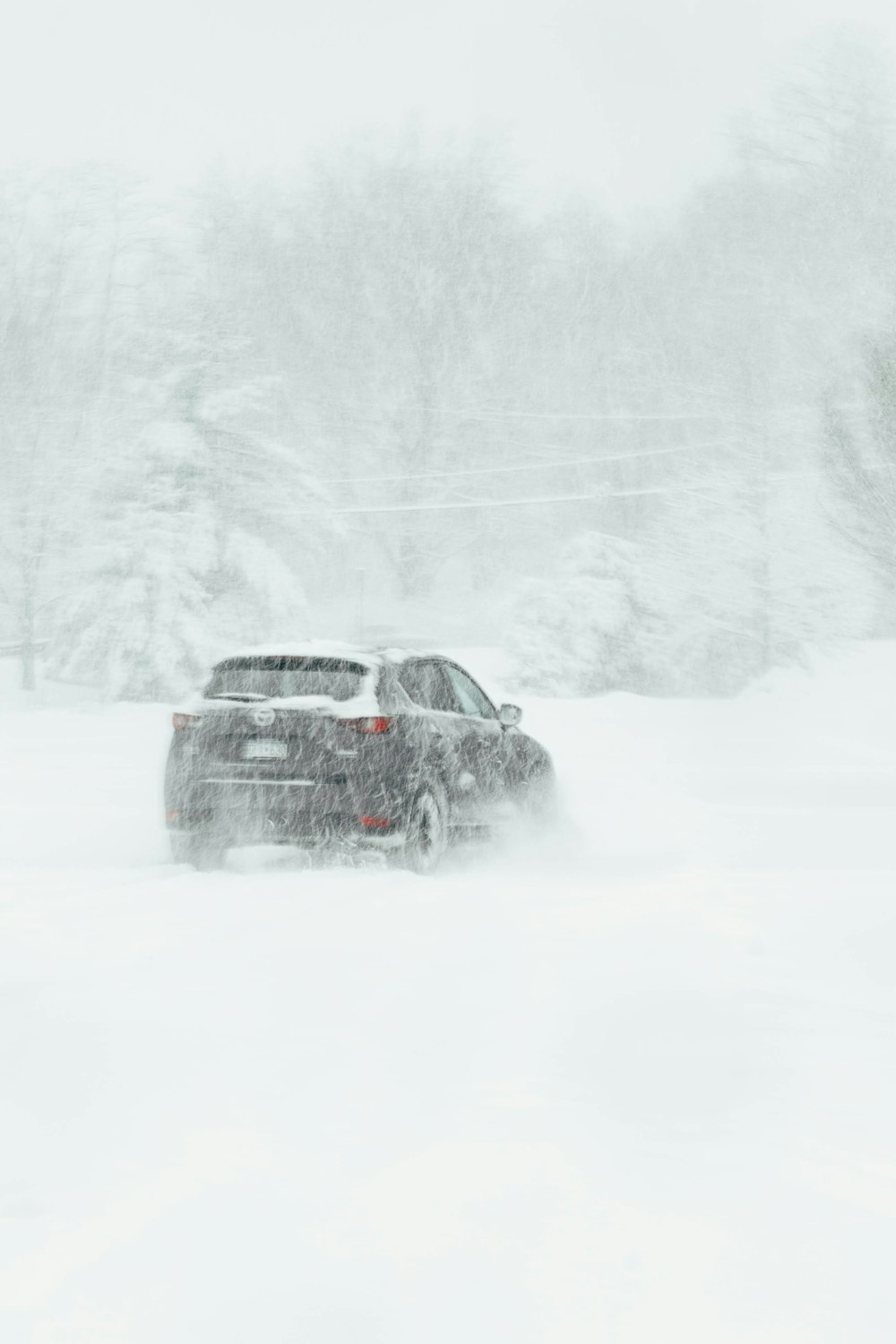 a car driving through a snow covered field