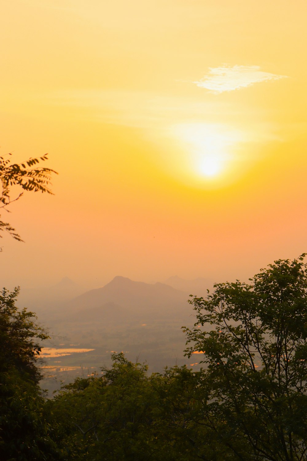 the sun is setting over a mountain range