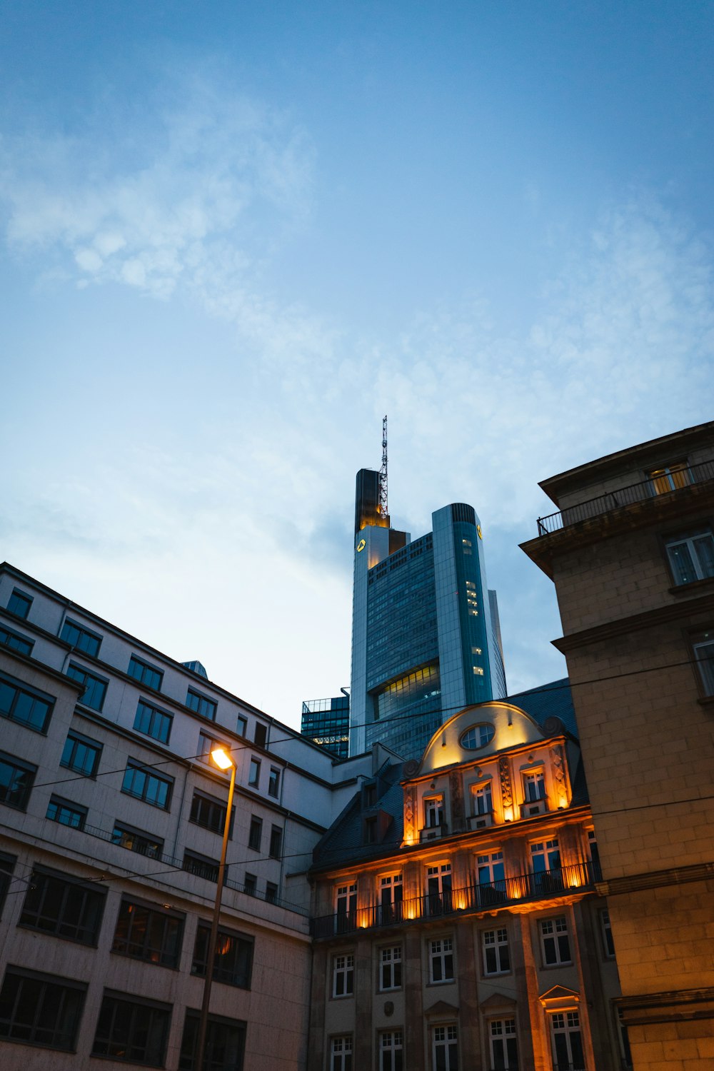 a tall building sitting next to other tall buildings