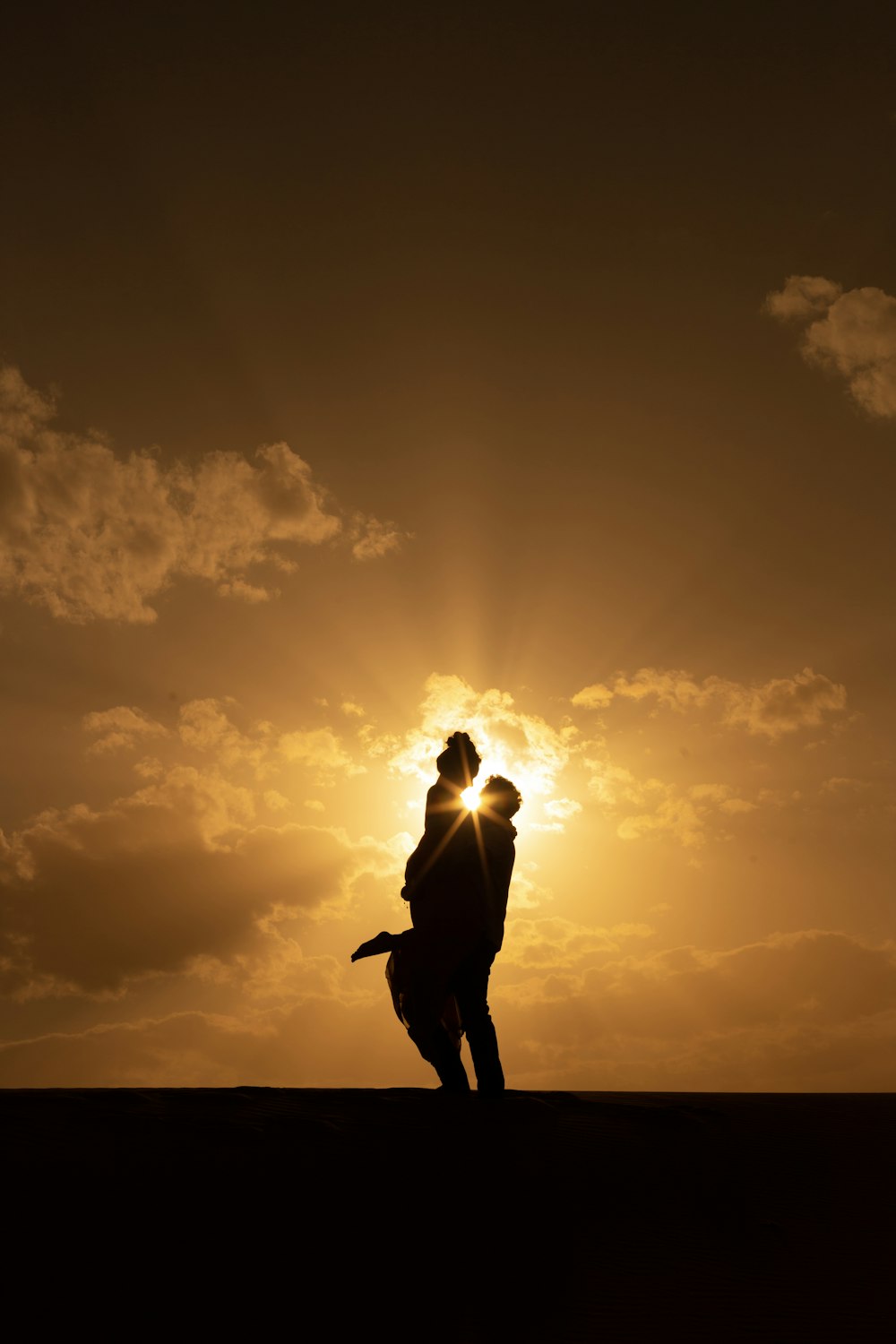 a couple of people that are standing in the sun