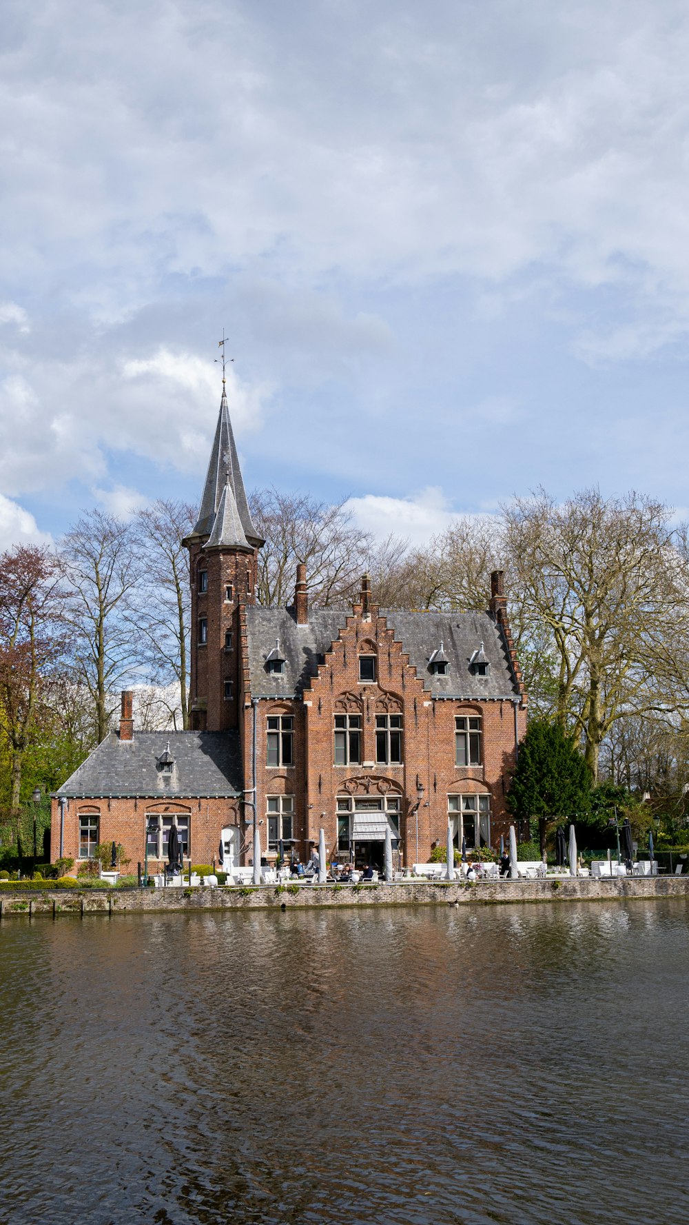 a large brick building sitting on top of a lake