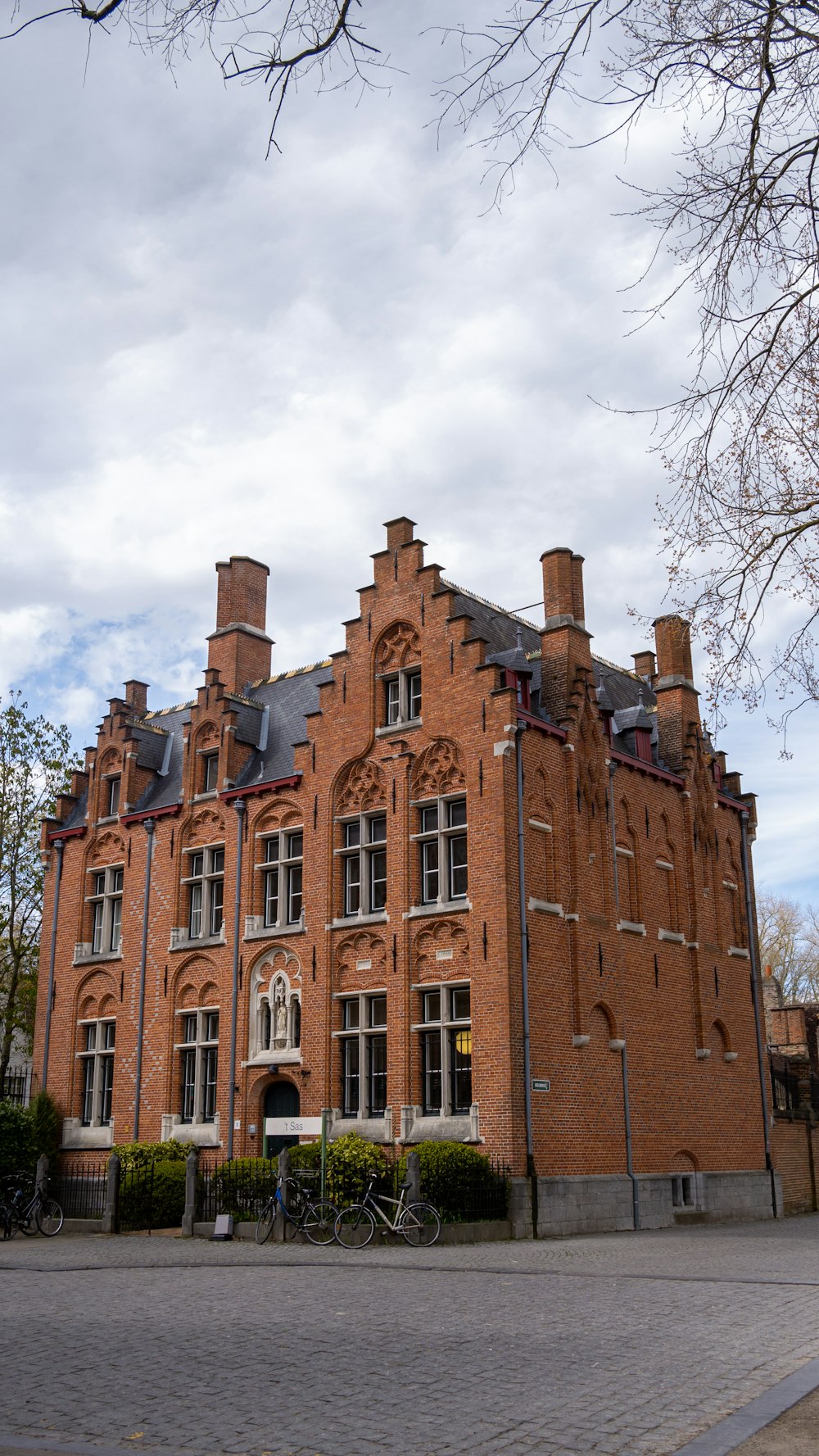 a large red brick building sitting on the side of a road