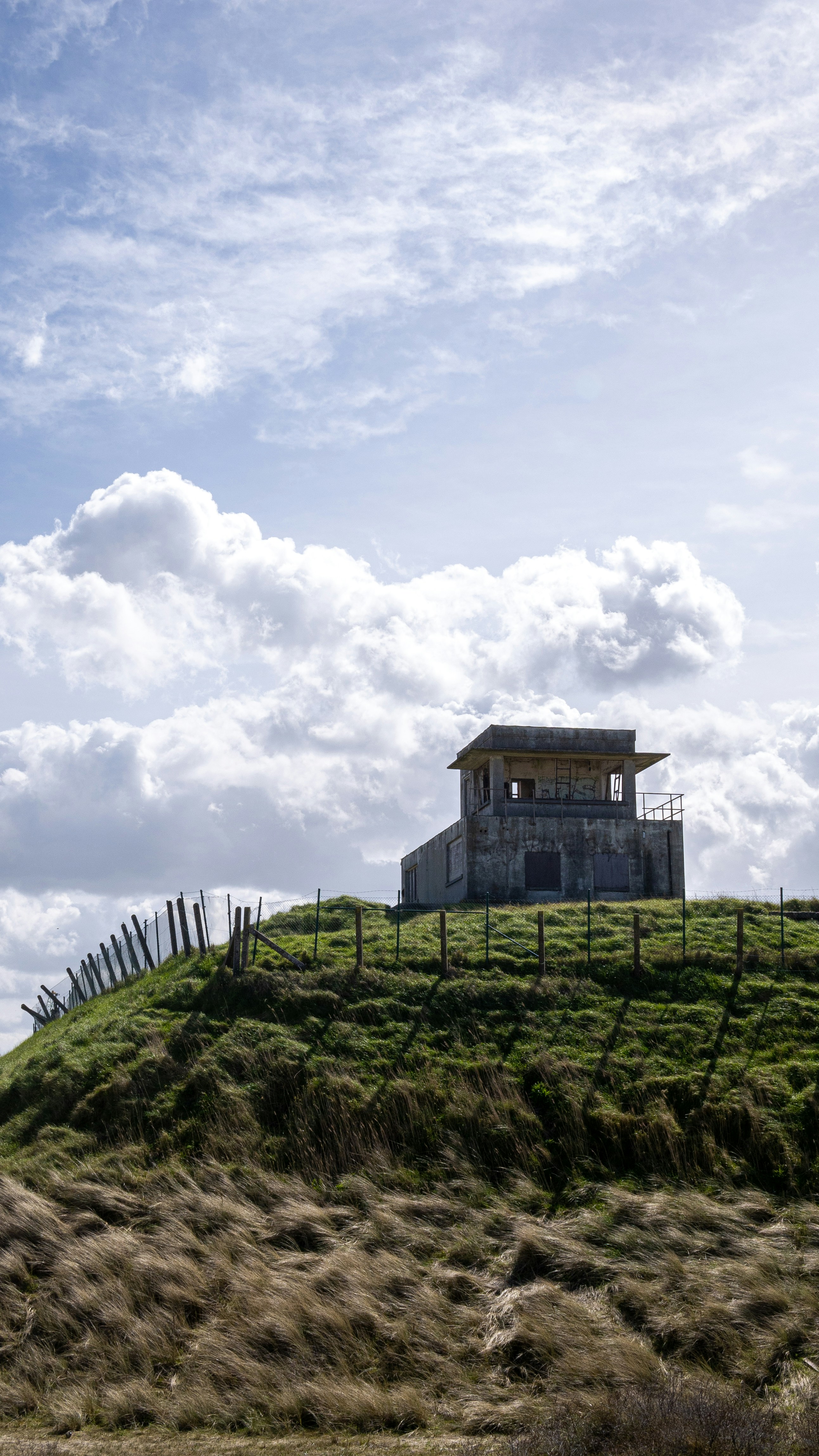 a house on a hill with a fence around it