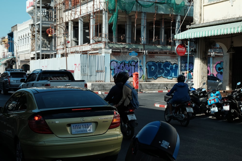 a group of people riding motorcycles down a street