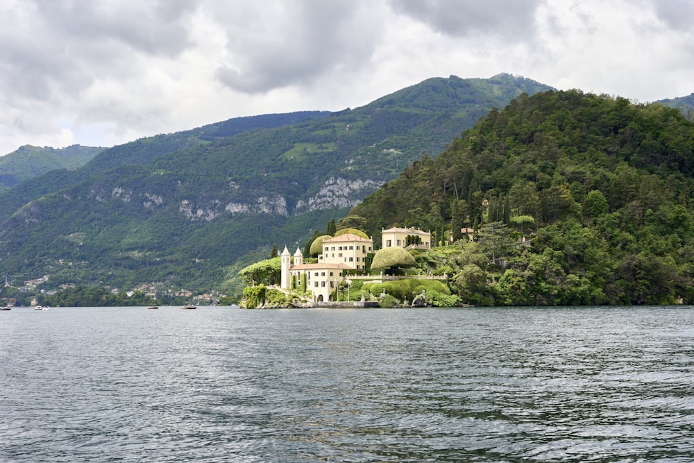 a large white house sitting on top of a lush green hillside