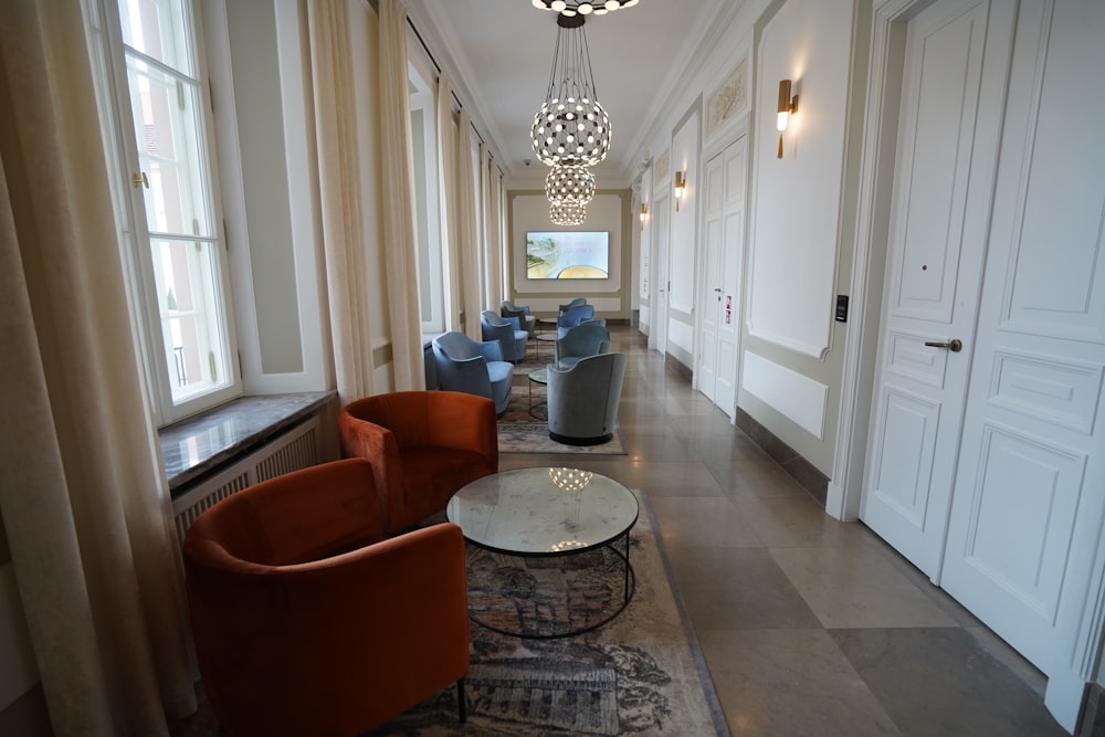 a long hallway with a chandelier hanging from the ceiling