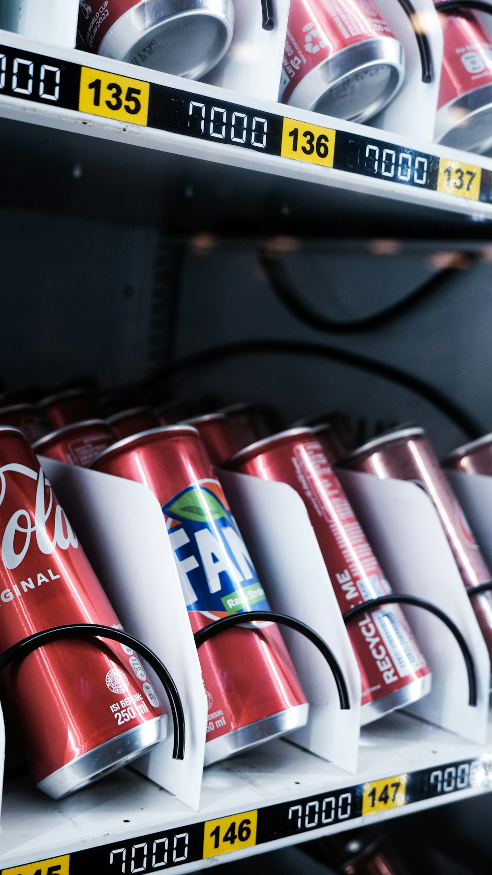 a row of red and white cups on a shelf