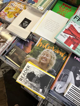A vibrant display of magazines fanned out on a wooden table.