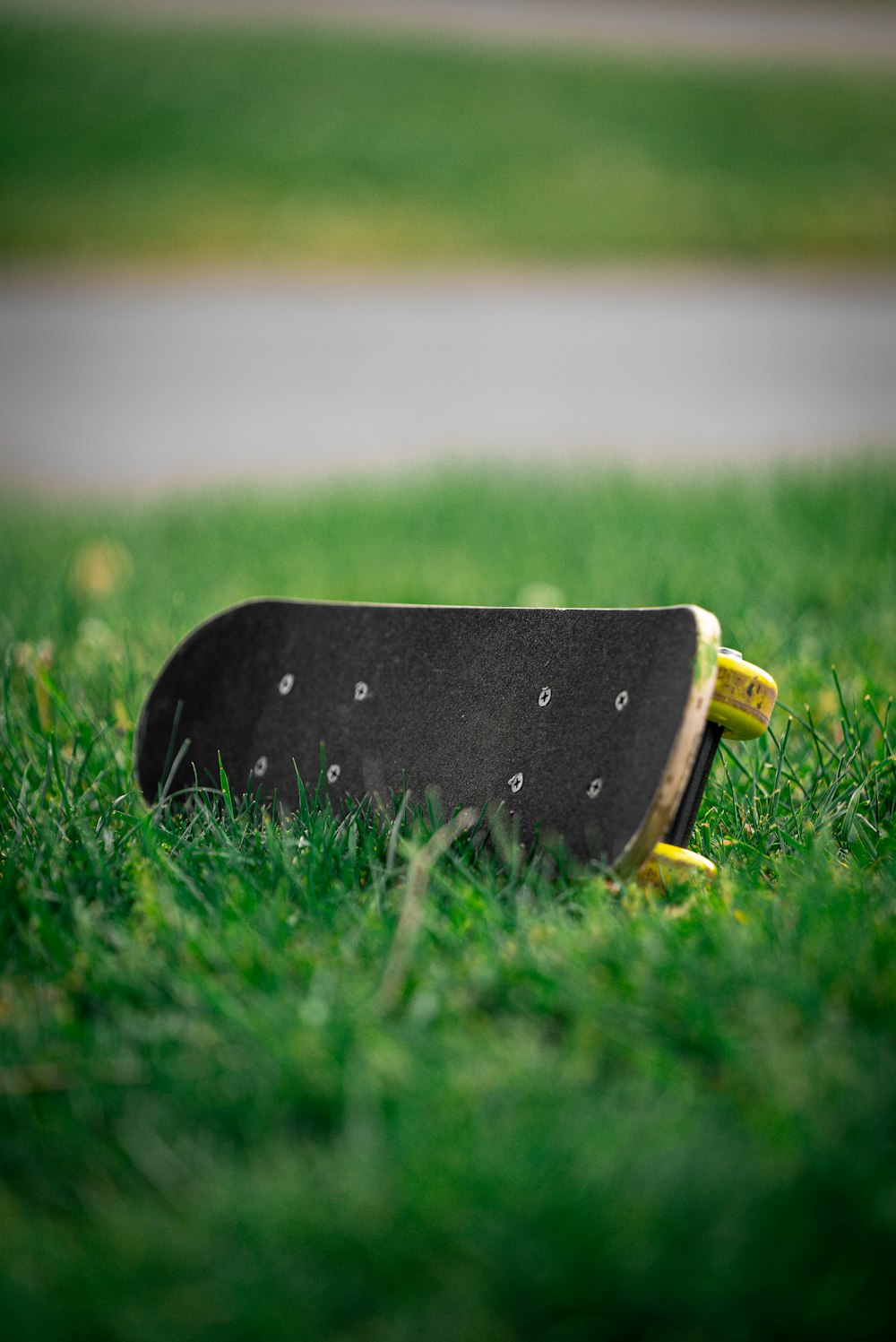 a skateboard laying on the ground in the grass