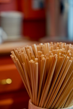 A collection of pasta-inspired sculptures displayed on a modern shelf.