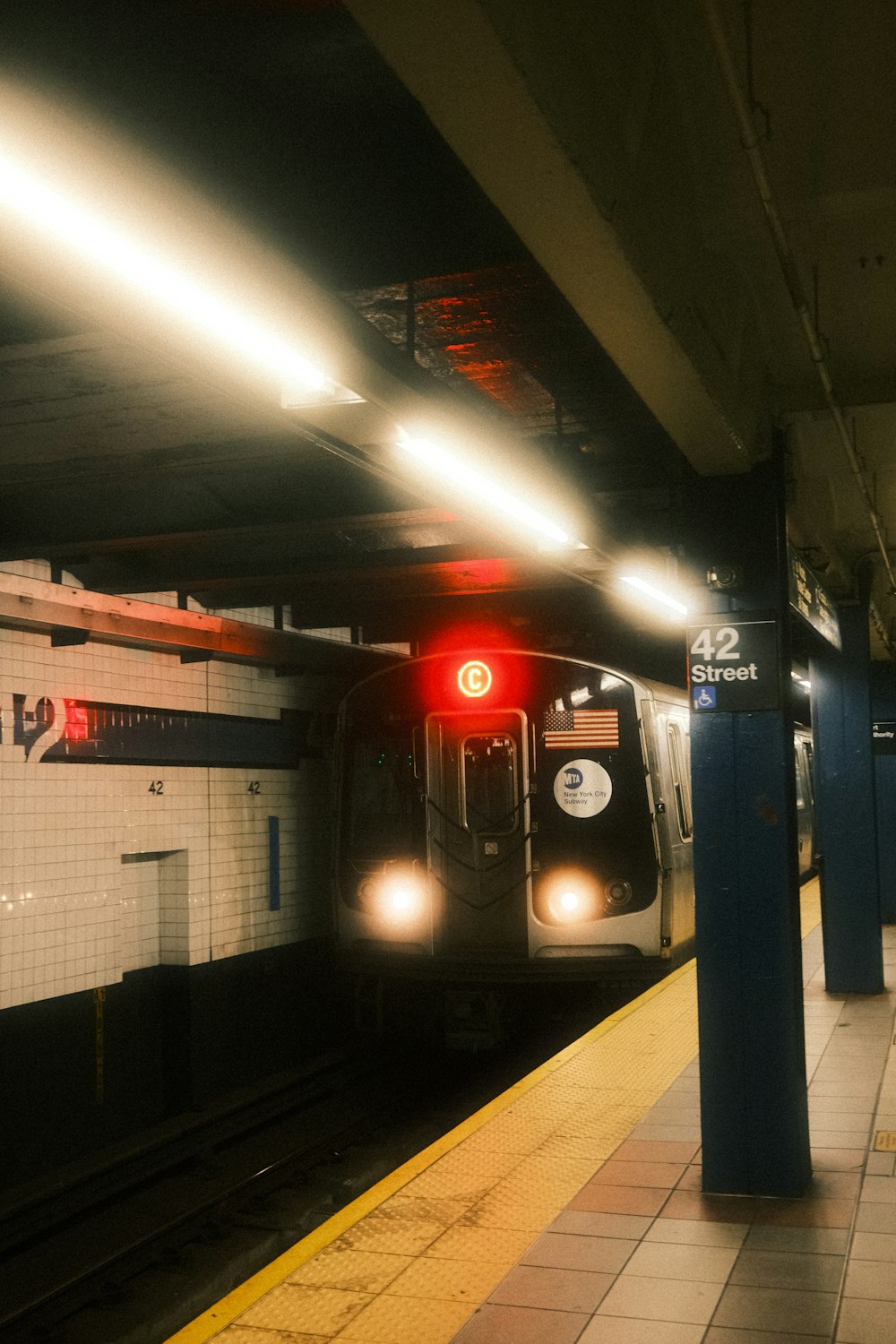 a subway train pulling into a train station