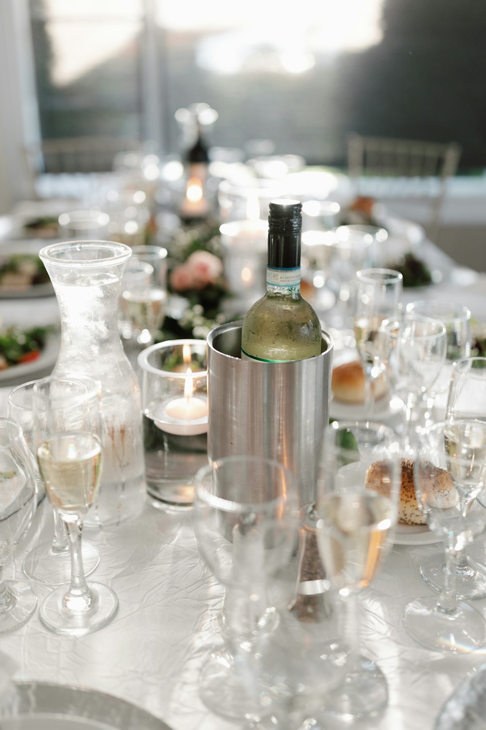 a table with a bottle of wine and glasses on it