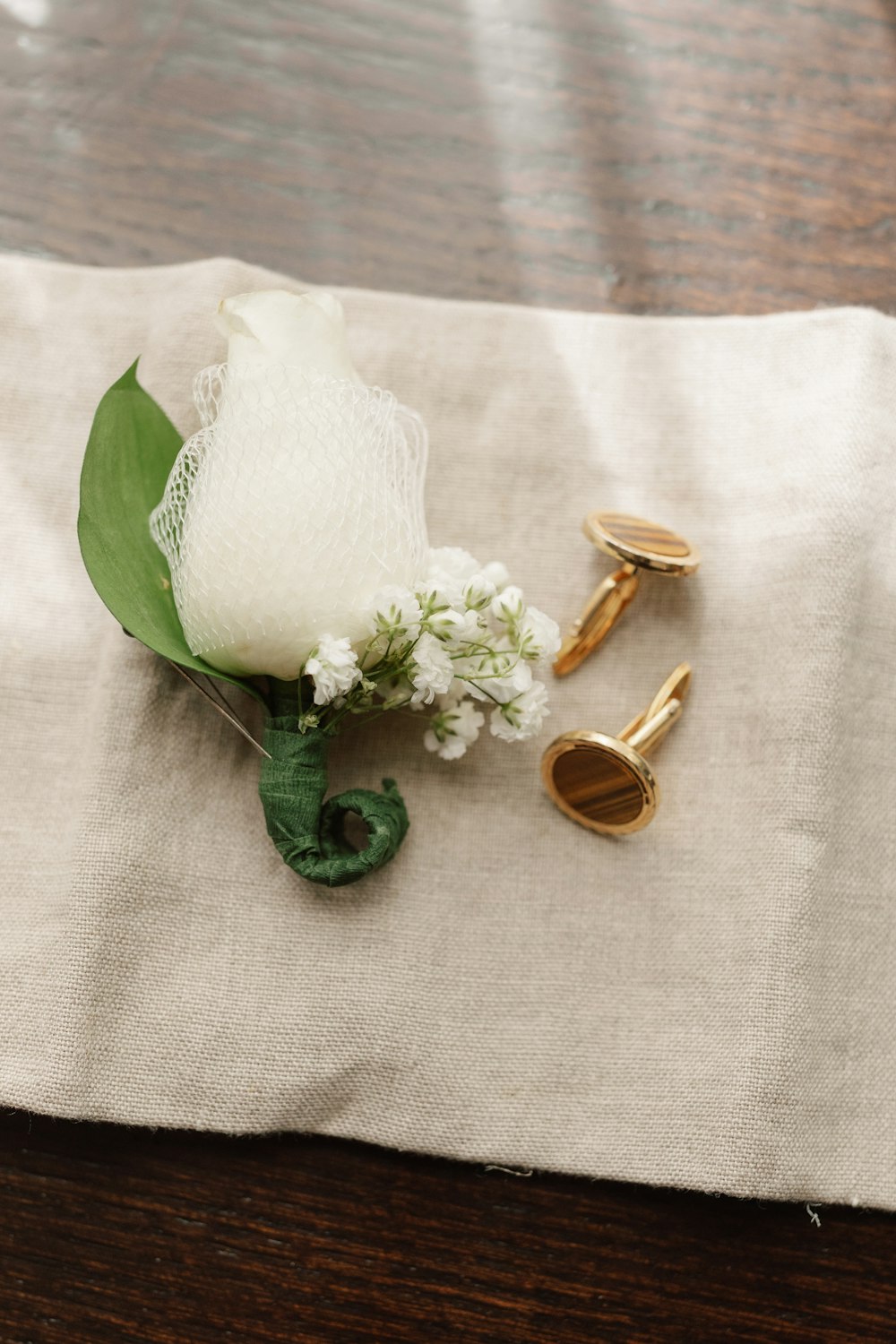 a white flower sitting on top of a wooden table