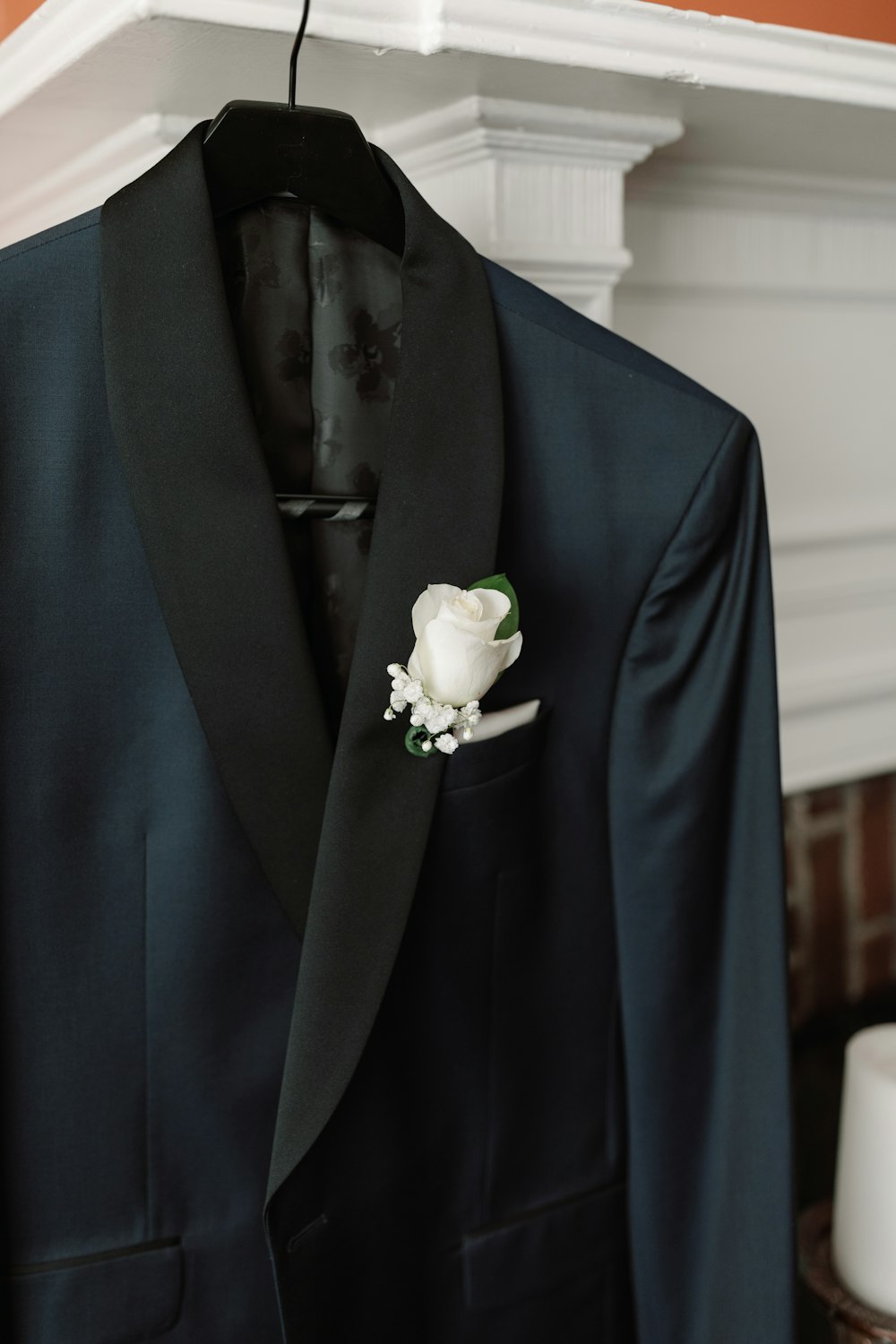a black suit with a white flower on it