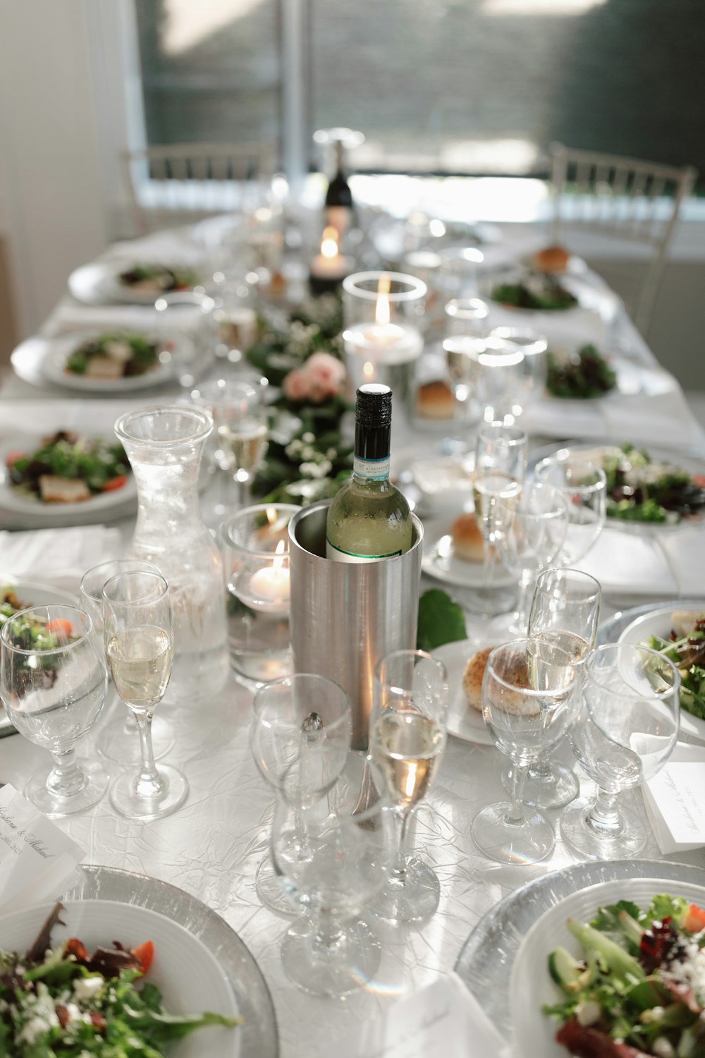 a long table with a bottle of wine on top of it