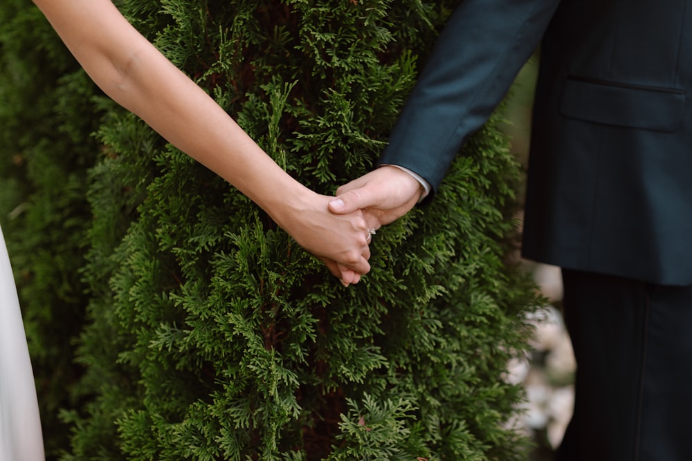 a close up of a person holding the hand of a person