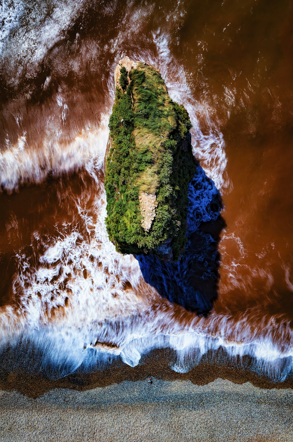 an aerial view of an island in the middle of the ocean