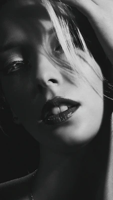 Black-and-white close-up of the band’s lead singer with dramatic shadow play reminiscent of classic gothic portraits.