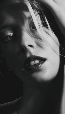A dramatic black and white portrait of an actor on set, mid-performance.
