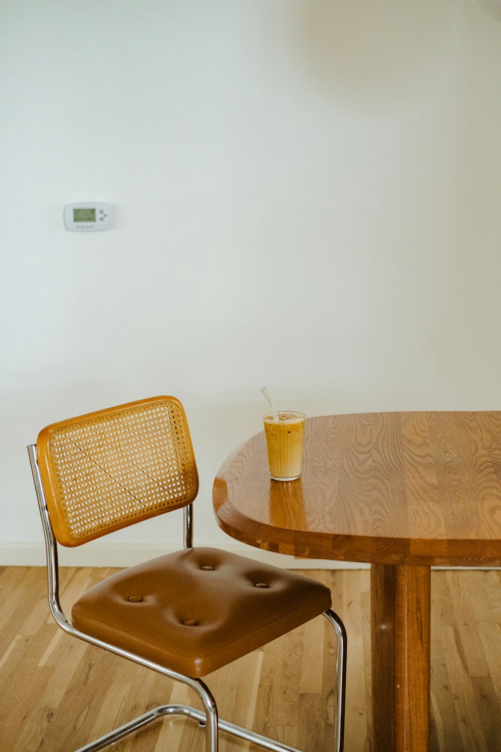 a chair and a table with a drink on it