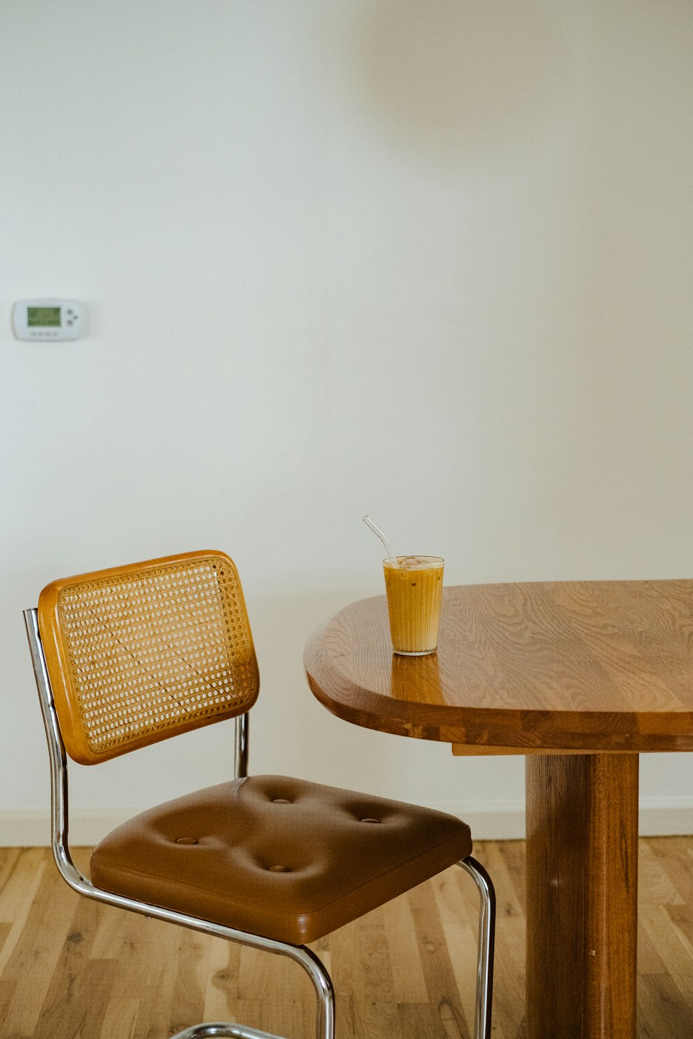 a chair and a table with a drink on it