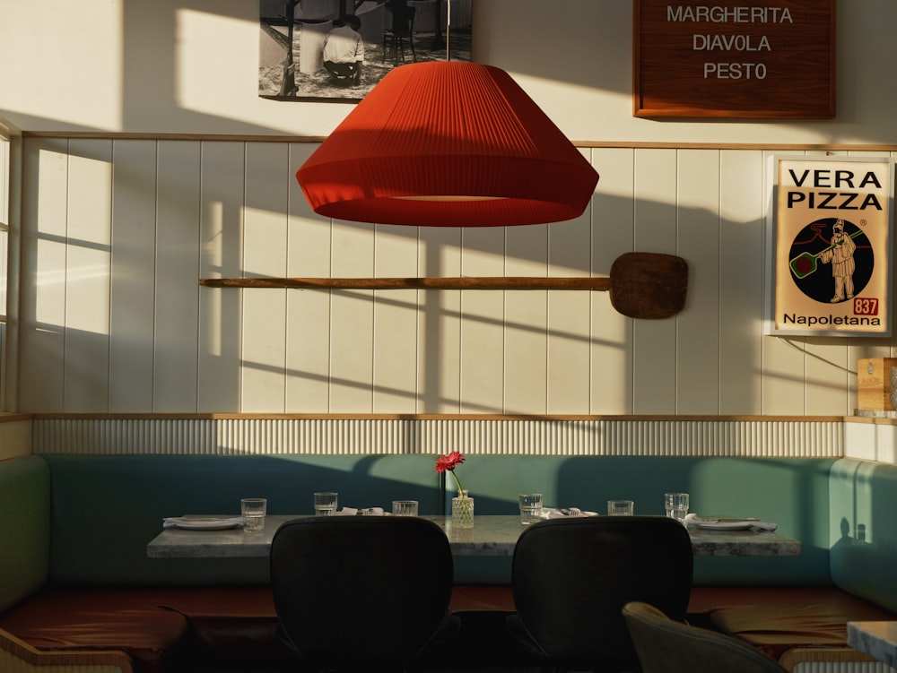 a restaurant with a red light hanging from the ceiling