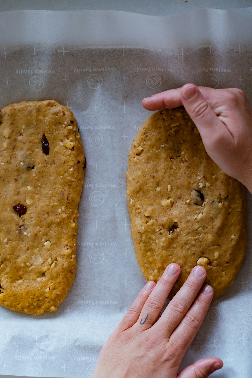 a person reaching for a cookie on a piece of paper