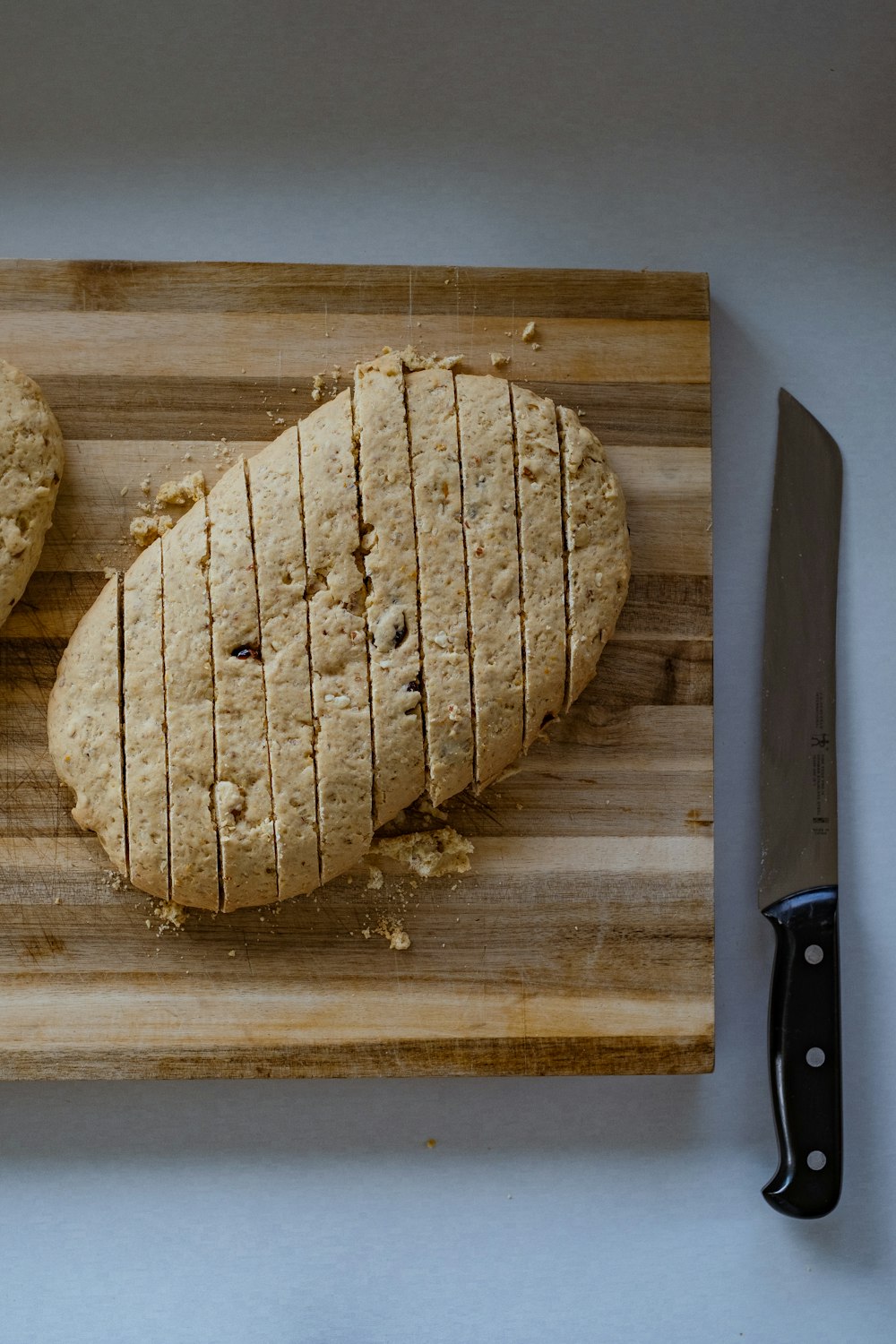 a wooden cutting board topped with two pieces of bread